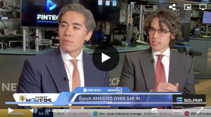 Two financial analysts in suits discuss crypto markets on a Bloomberg "Market Movers" segment, with on-screen graphics highlighting "EasyA AMASSES OVER $4B IN ITS ECOSYSTEM" alongside Solana branding and ticker symbols like XRP, SOL, and S&P 500. The image relates to the post by providing a financial news context in which analysts might address the speculative question of whether XRP could reach $1,000.