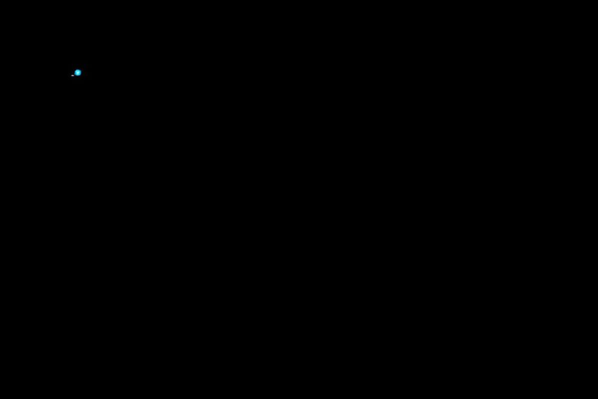 The image shows a black square with a blue dot in the center of it. The background appears to be a dark gray color. There are no other objects or texts present in the image.