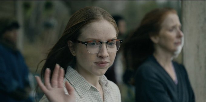 The image shows a woman with glasses standing next to another person who appears to be an older woman wearing a black jacket. The two women are positioned close together, possibly having a conversation or sharing some personal information. In the background, there's a man dressed in a blue shirt and a woman wearing a black coat. They seem to be part of a larger group, as indicated by the text "good night everyone, peace & more usdt be onto us this week". The overall atmosphere appears to be casual and friendly.