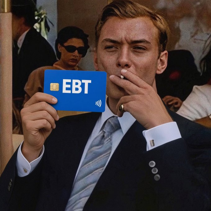 Edited photo of Leonardo DiCaprio from The Great Gatsby smoking a cigarette, holding a blue card that reads 'EBT' with a chip and Wi-Fi symbol superimposed over it.