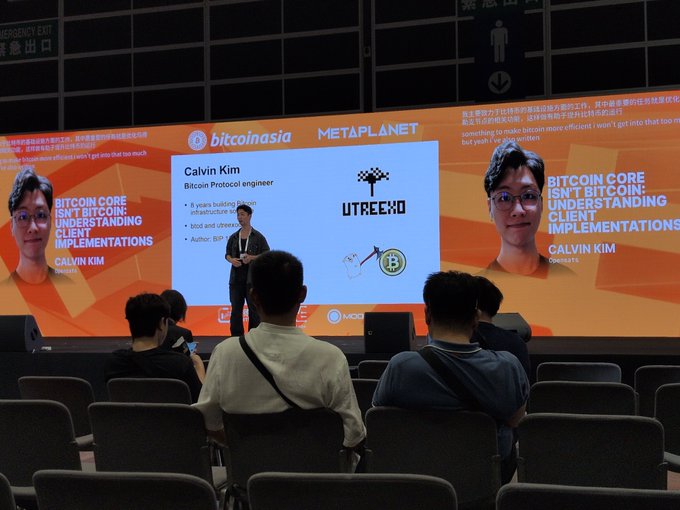 A Bitcoin conference presentation showing Calvin Kim, Bitcoin Core Protocol engineer from UTreexo, speaking on stage about 'Bitcoin Core Isn't Bitcoin: Understanding Client Implementations' at the Bitcoinasia Metaplanet event.