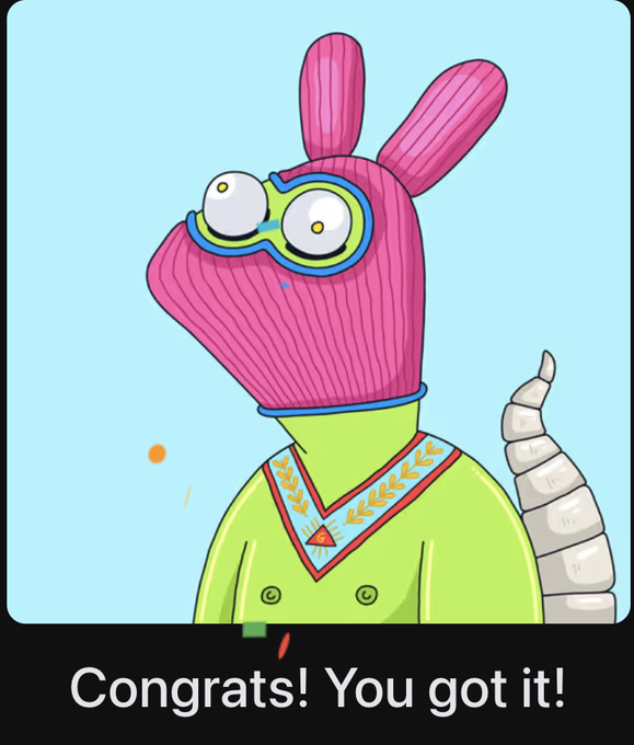A cartoon character wearing a pink bunny-eared balaclava and blue goggles smiles against a light blue background, with the text "Congrats! You got it!" displayed below. The whimsical design reflects the playful NFT collectible that the user added to their collection from the Creepz collection.