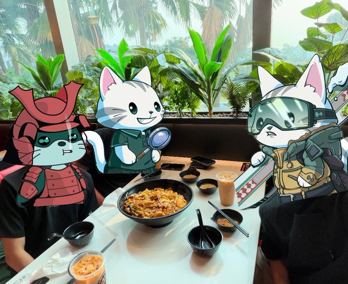 Three cat characters (one in samurai armor, one with a magnifying glass, one in tactical gear with a sword) are digitally overlaid onto people sitting at a restaurant table with a bowl of noodles and iced drinks.