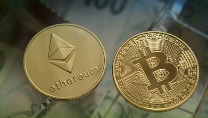Two physical cryptocurrency coins—an Ethereum coin labeled "ethereum" and a Bitcoin coin inscribed with "BITCOIN DIGITAL DECENTRALIZED PEER TO PEER" and "FINE COPPER"—rest on top of U.S. dollar bills, visually representing the $288M in seized Bitcoin and Ether that the U.S. government recently transferred to Coinbase Prime.