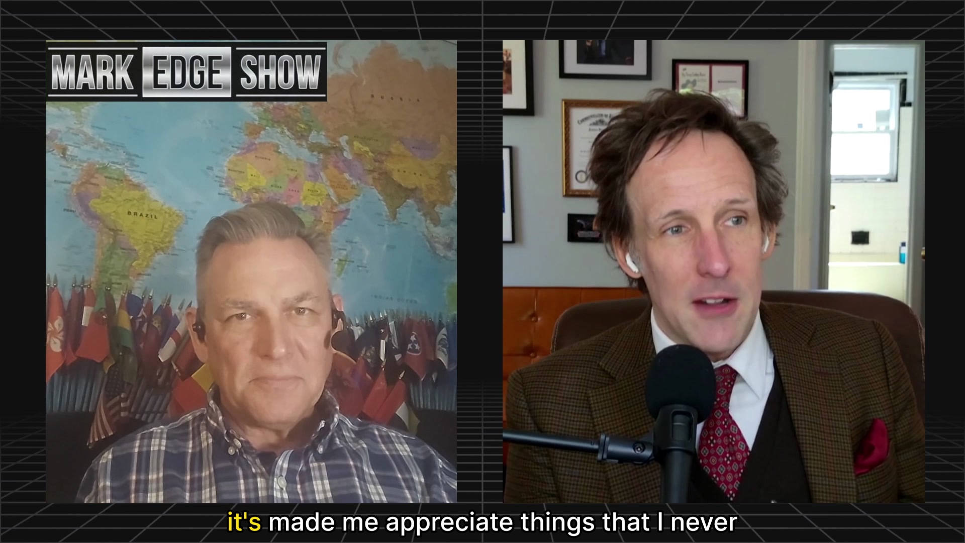 The image shows two men sitting behind microphones at a podcast recording booth. One man has short hair wearing a plaid shirt while the other has long hair wearing a brown suit with a red tie. The background features a map of the world, suggesting that they are discussing global issues or sharing their perspectives on various topics.