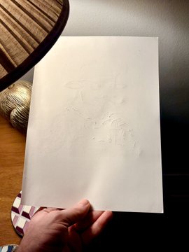 A hand holds up a piece of thick paper showing faint tactile indentations on its back, demonstrating how braille paper preserves the embossed texture without tearing, complementing the artist Mallow's description of the physical artwork being shipped to the NFT auction winner.