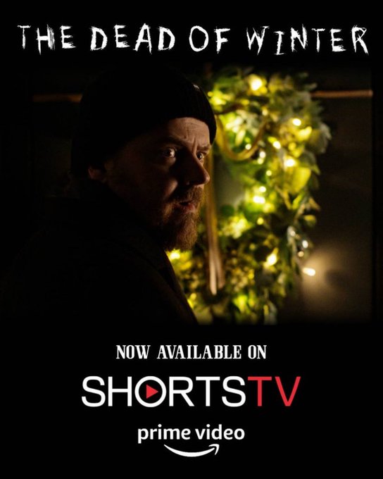 A promotional poster for 'THE DEAD OF WINTER' featuring a bearded man in a beanie looking over his shoulder, with text reading 'NOW AVAILABLE ON SHORTSTV' and 'prime video'.