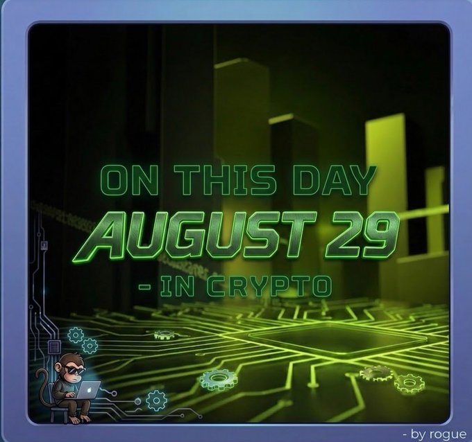 A digital graphic titled 'ON THIS DAY AUGUST 29 - IN CRYPTO' by rogue, featuring a green tech-themed background with circuit boards and a cartoon monkey at a laptop.
