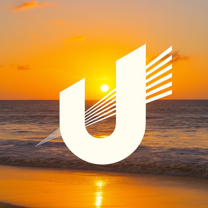 A white stylized 'U' logo with wings is overlaid on a vibrant sunset scene at the beach.