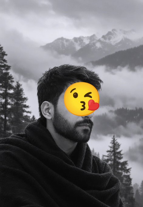 A black and white photo of a bearded man in a dark robe against a misty mountain backdrop, his face partially obscured by a kissing emoji.