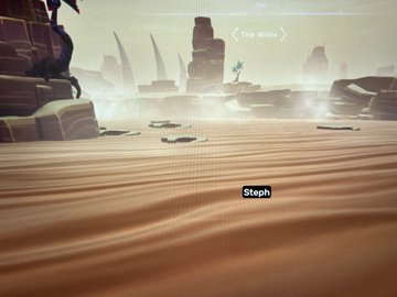A screenshot from a game showing a desert landscape with rock formations, where the name 'Steph' appears above a character, and 'THE BEGIN' is displayed at the top.