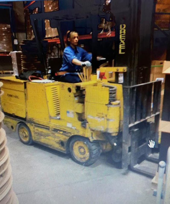 A forklift operator with 26 years on the job drives a yellow Drexel lift inside a warehouse, with the text expressing hope that XRP cryptocurrency will "break them out" of their longtime career.