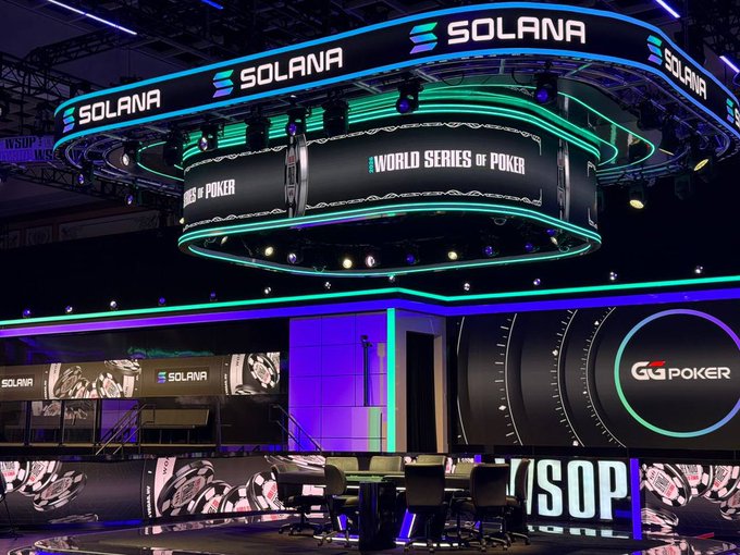 The image shows a large, illuminated stage with a sign that reads "World Series of Poker", indicating that it might be an event related to poker or a casino setting.
