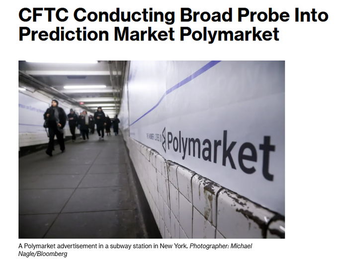 The image shows a Polymarket advertisement displayed in a New York City subway station, featuring the company's logo on a white tiled wall as commuters walk by. This visual underscores the prediction market's growing mainstream visibility even as federal regulators, including the CFTC, launch a formal investigation into the platform alongside a consumer-protection lawsuit naming CEO Shayne Coplan personally.