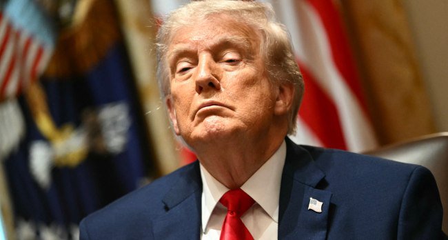 This image shows Donald Trump, whose financial disclosure reportedly revealed about $1.4 billion in crypto related income for 2025, largely from the $TRUMP meme coin.
