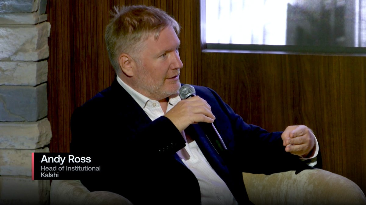 Interview shot of Andy Ross, identified by on-screen text as 'Head of Institutional' at Kalshi, speaking into a microphone while wearing a dark blazer over a white shirt.