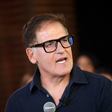 A middle-aged man with dark hair and black-rimmed glasses, wearing a dark polo shirt, speaks into a microphone with an animated expression. The image likely illustrates the "billionaires" referenced in the post, with the speaker appearing to be promoting or endorsing chip stocks at elevated prices—a scenario the post warns against, comparing it to buying XRP at its peak.