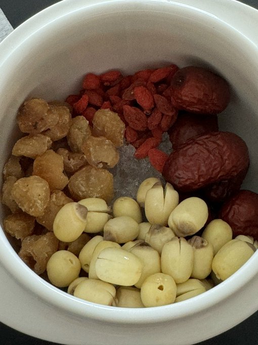 A bowl filled with goji berries, dried jujubes, lotus seeds, and longans sits above a text snippet regarding Zane's future content focus on life experiences, finances, and crypto. The image serves as a metaphor for the diverse and "mixed" nature of the topics Zane intends to cover.