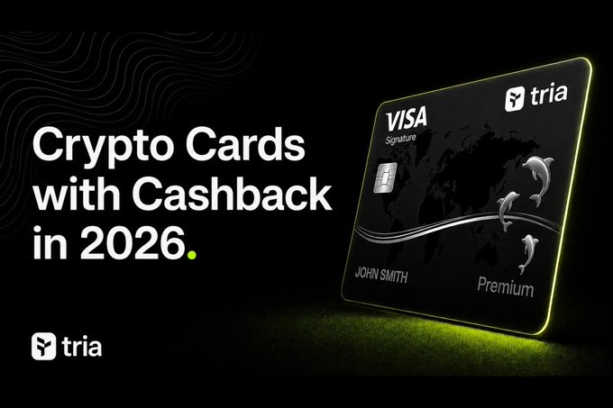 A promotional advertisement for 'tria' featuring a black Visa Signature Premium credit card with dolphin designs, promoting 'Crypto Cards with Cashback in 2026'.