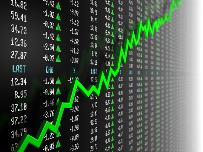 The image shows a close-up view of a stock chart that displays an upward trend, with the stocks reaching record highs. The graph also includes a line indicating Bitcoin's performance over time. There are multiple text elements on the screen related to oil prices, specifically mentioning a 60-day U.S.-Iran scenario and Bitcoin performing well despite an unfavorable global market situation.