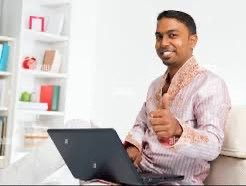 A smiling South Asian man in traditional attire gives a thumbs-up while using a laptop, playfully subverting the post's "web3 girl" trope by suggesting the recipient of online money transfers might actually be a man at home rather than the expected online persona.