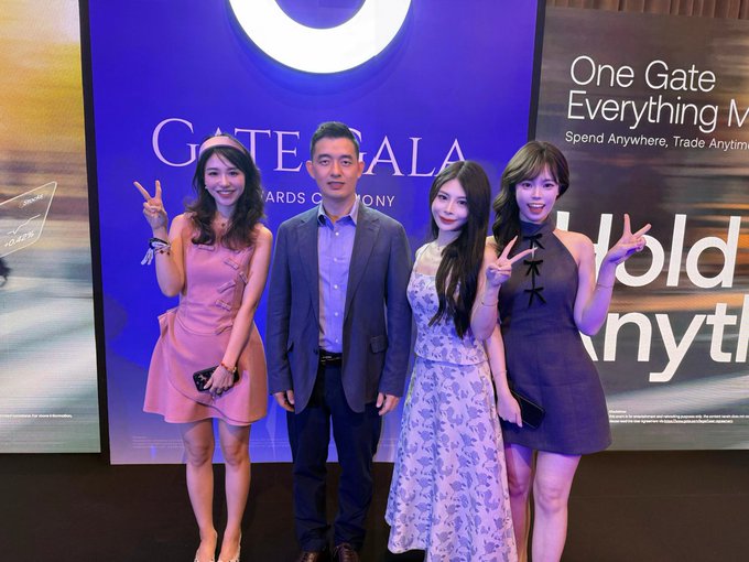 A group of four people pose together at the Gate Gala Awards Ceremony, with a large screen behind them displaying "One Gate Everything V" and "Spend Anywhere, Trade Anyti..." The man in the center, presumably Han_Gate, stands with three women (including @Gate_Leisel and @Gate_Jessie1 mentioned in the caption), all making peace signs for the photo in front of the branded blue Gate.io event backdrop.