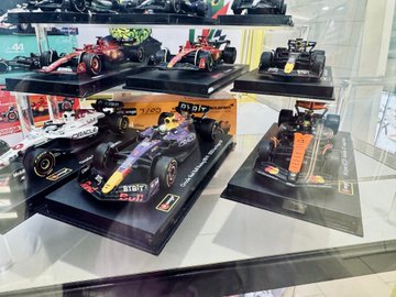 This image shows a collection of Formula 1 model cars, some of which feature prominent cryptocurrency sponsor logos like "Bybit" and "Oracle." The display of these sponsored F1 cars directly illustrates the post's question about the crypto world's influence on Formula 1.