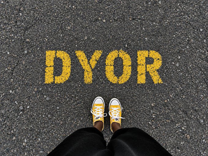 A person wearing yellow Converse sneakers stands on asphalt pavement looking down at the bold yellow text "DYOR" (Do Your Own Research) spray-painted or stenciled on the road, fitting the post's sentiment about sharing timeless advice.