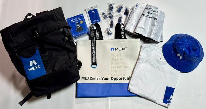A collection of MEXC 8th anniversary commemorative merchandise is displayed, including a black backpack with the MEXC logo, a blue bucket hat, a white t-shirt, a lanyard, a "MEXCmize Your Opportunities" banner listing "Profit, Wealth, Dreams, Freedom, Style, Growth," small bottles, and packaged accessories labeled "MEXCmize Your Opportunities," showcasing the variety of promotional items received from the cryptocurrency exchange.