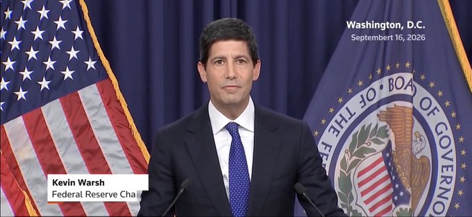 A news broadcast frame shows a man at a podium with an American flag, labeled 'Kevin Warsh, Federal Reserve Chairman,' in Washington, D.C., dated September 16, 2026.