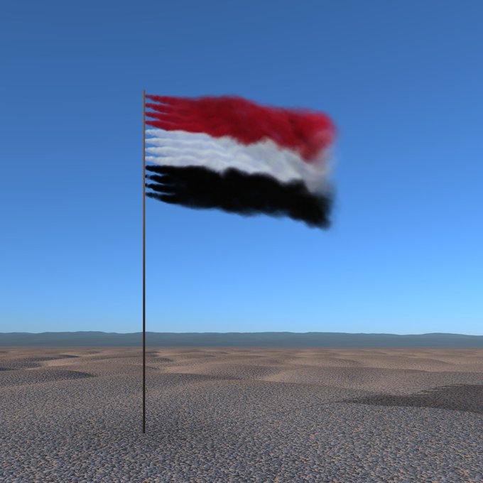 A red, white, and black flag waving on a pole against a clear blue sky in a barren desert landscape.