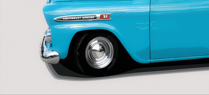 A close-up image of the rear quarter panel and wheel of a turquoise Chevrolet Apache 31 vintage pickup truck.