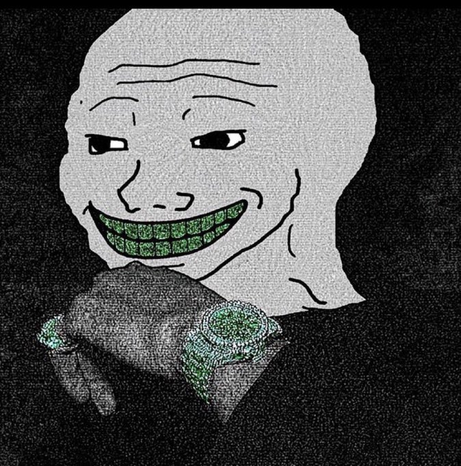 A grainy meme image showing a bald, smug-looking cartoon character with a wide green-toothed grin holding a dark, lumpy object against a black background.