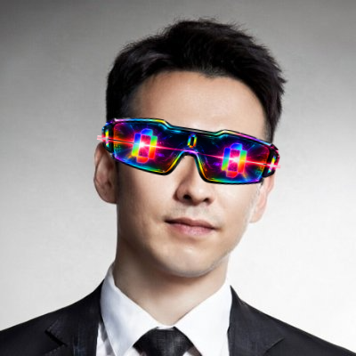 A man in a black suit wears futuristic wraparound sunglasses displaying a colorful rainbow grid pattern.