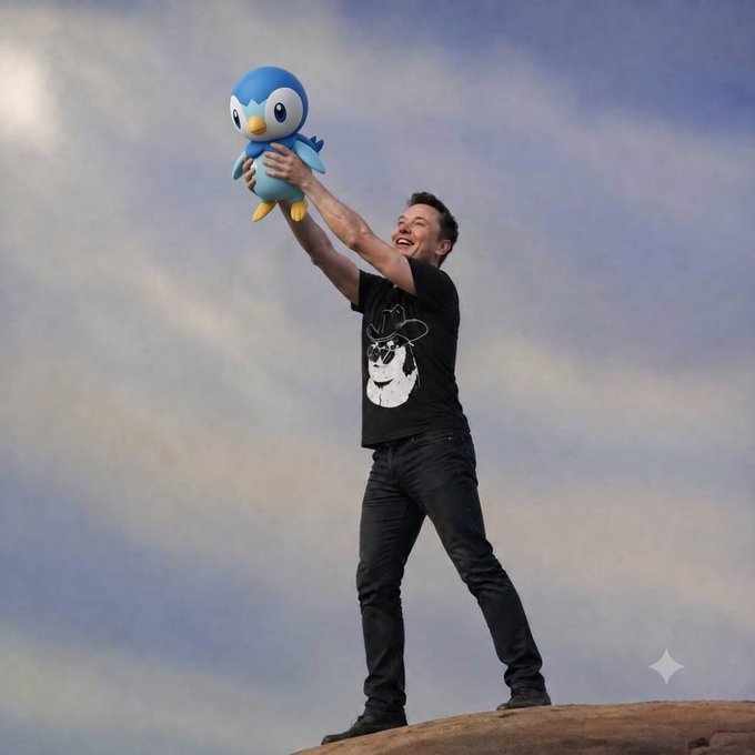 Elon Musk stands on a rocky outcrop holding up a Piplup plush toy, wearing a black t-shirt with a graphic, jeans, and black boots against a cloudy sky.
