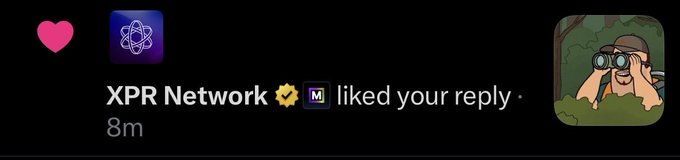 A social media notification showing a pink heart reaction, indicating that 'XPR Network' with a verified badge liked a reply, timestamped '8m'.