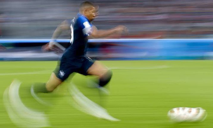 A soccer player in a dark blue #10 jersey sprints across the field chasing a ball in a motion-blurred action shot. The image playfully captures the meme's theme of dodging requests for crypto wallet addresses, suggesting the person "ran away" from sharing their Solana wallet.
