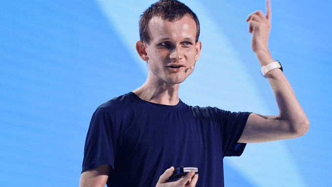 iced coffee with a white lid, a blue phone case, and a watch on the wrist of an individual speaking at a podium against a light blue background.