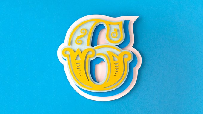 A stylized, ornate yellow and white monogram logo with decorative flourishes, mounted on a bright blue textured background.