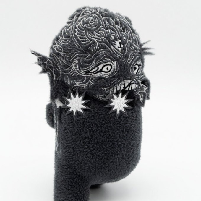 The image features a black and white stuffed animal, possibly a teddy bear or a doll, with two star-shaped earrings attached to its ears. The text "An OMB runs the Bitcoin Magazine tweets" suggests that there might be an ongoing discussion about Bitcoin on social media platforms like Twitter. This could imply that someone is bearish on the concept of Ordinals (ordinal numbers) and might have a negative opinion or stance regarding it.