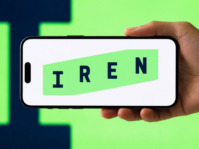A hand holding a smartphone displaying the word 'IREN' on a green screen, set against a matching green background.