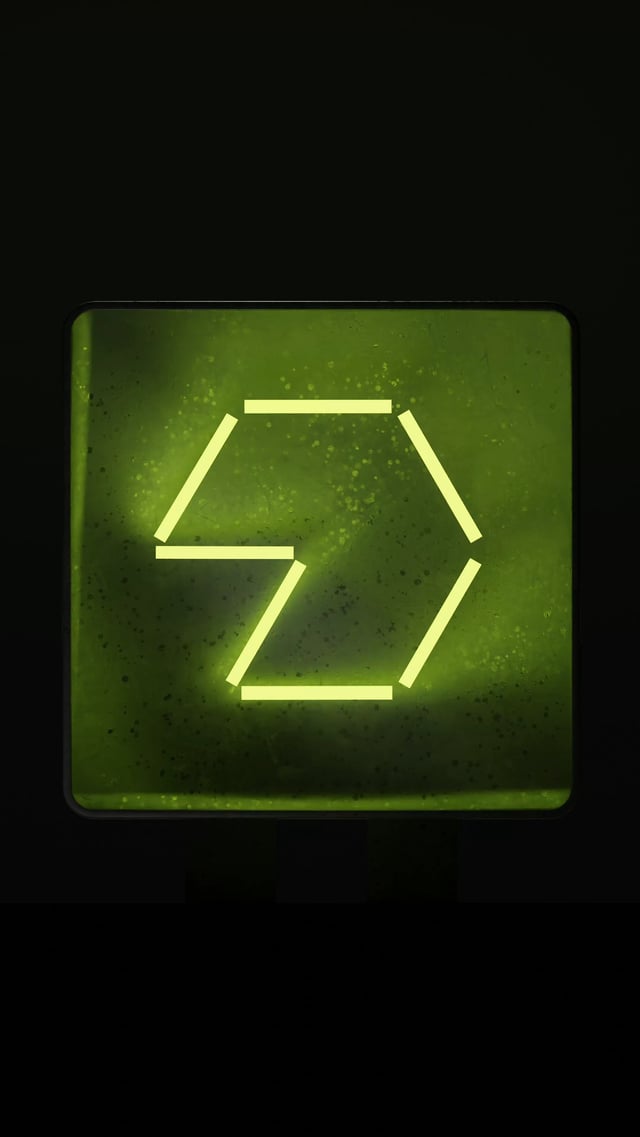 The image features a neon green square sign with a triangle shape, which appears to be a symbol or logo for Raiku, a company based in Finland. The sign has a unique design, as it uses neon lights instead of traditional colors. The background is black and out of focus, drawing attention to the neon sign. The text "rkuSOL" can also be seen on the image, which might provide more information about the company or its product.