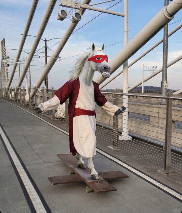 A surreal image of a white horse wearing a red superhero mask and a red and cream robe, standing on a wooden skateboard on a modern cable-stayed bridge.