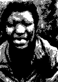 A heavily pixelated, high-contrast black-and-white image shows the distorted face of a person wearing a hood.