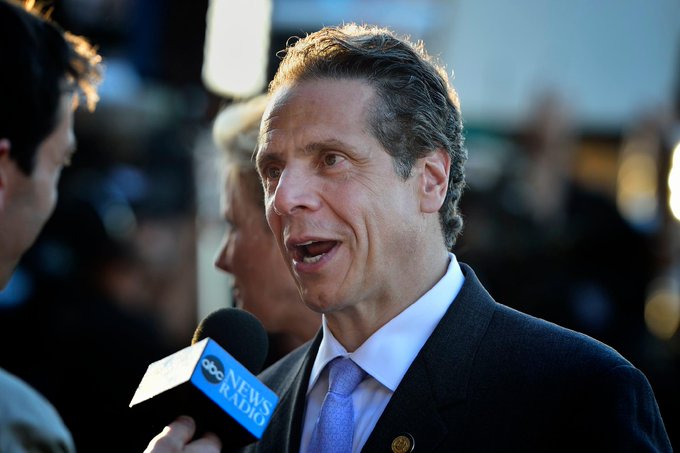 Former Governor Andrew Cuomo speaks into an ABC News Radio microphone, referencing New York's 2014 BitLicense in a recent statement about US crypto regulation.