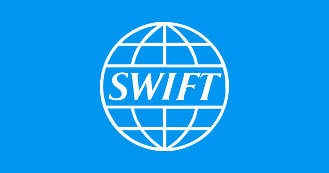 The image displays the SWIFT logo, featuring a white globe with grid lines encircling the word "SWIFT" on a blue background. The post humorously questions whether Wells Fargo would accept cryptocurrency (pETH) for mortgage payments, with the SWIFT logo suggesting a contrast between traditional banking/financial messaging systems and decentralized crypto transactions.