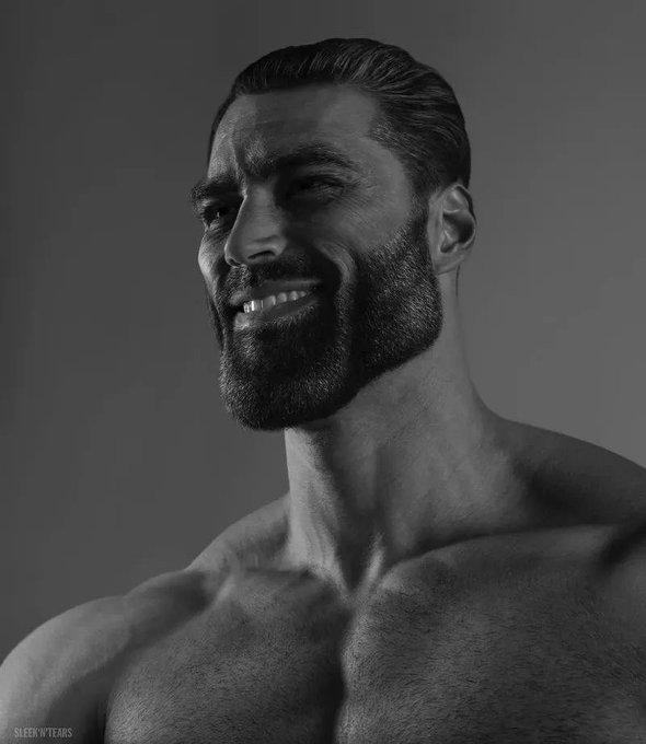 A black-and-white portrait of a smiling, bearded, muscular man with slicked-back hair, credited to "SLEEK N TEARS" in the corner.