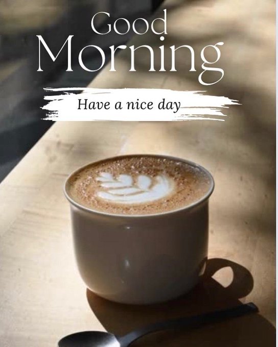 A 'Good Morning' greeting graphic showing a cup of cappuccino with latte art on a wooden table, with the text 'Have a nice day'.