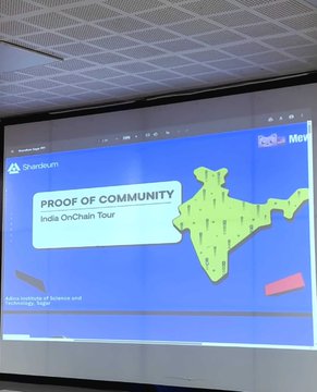 The image shows a projector displaying a slide titled "PROOF OF COMMUNITY - India OnChain Tour" featuring a map of India and the ChainGPT logo, presented at a campus workshop. This visual relates to the post by showcasing the educational outreach event where the Proof of Community India OnChain Tour engaged students during a stop on the multi-city tour.