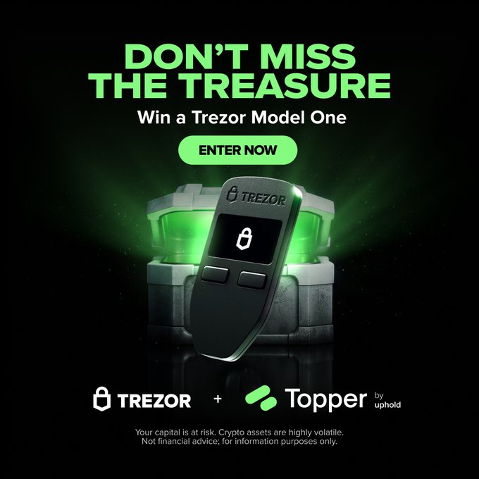 A promotional advertisement reads 'DON'T MISS THE TREASURE — Win a Trezor Model One' with an ENTER NOW button, showing a Trezor hardware wallet emerging from a glowing green chest, branded by Trezor and Topper by Uphold.